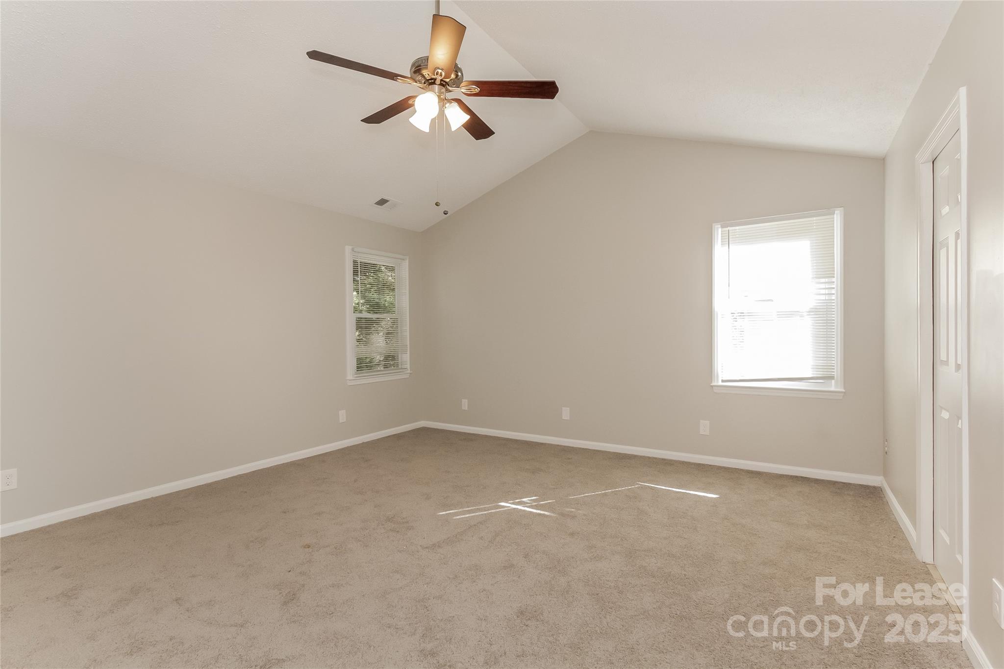 926 Eldorado Avenue Charlotte, NC 28262 - Photo 12 of 17 an empty room with a window and a fan
