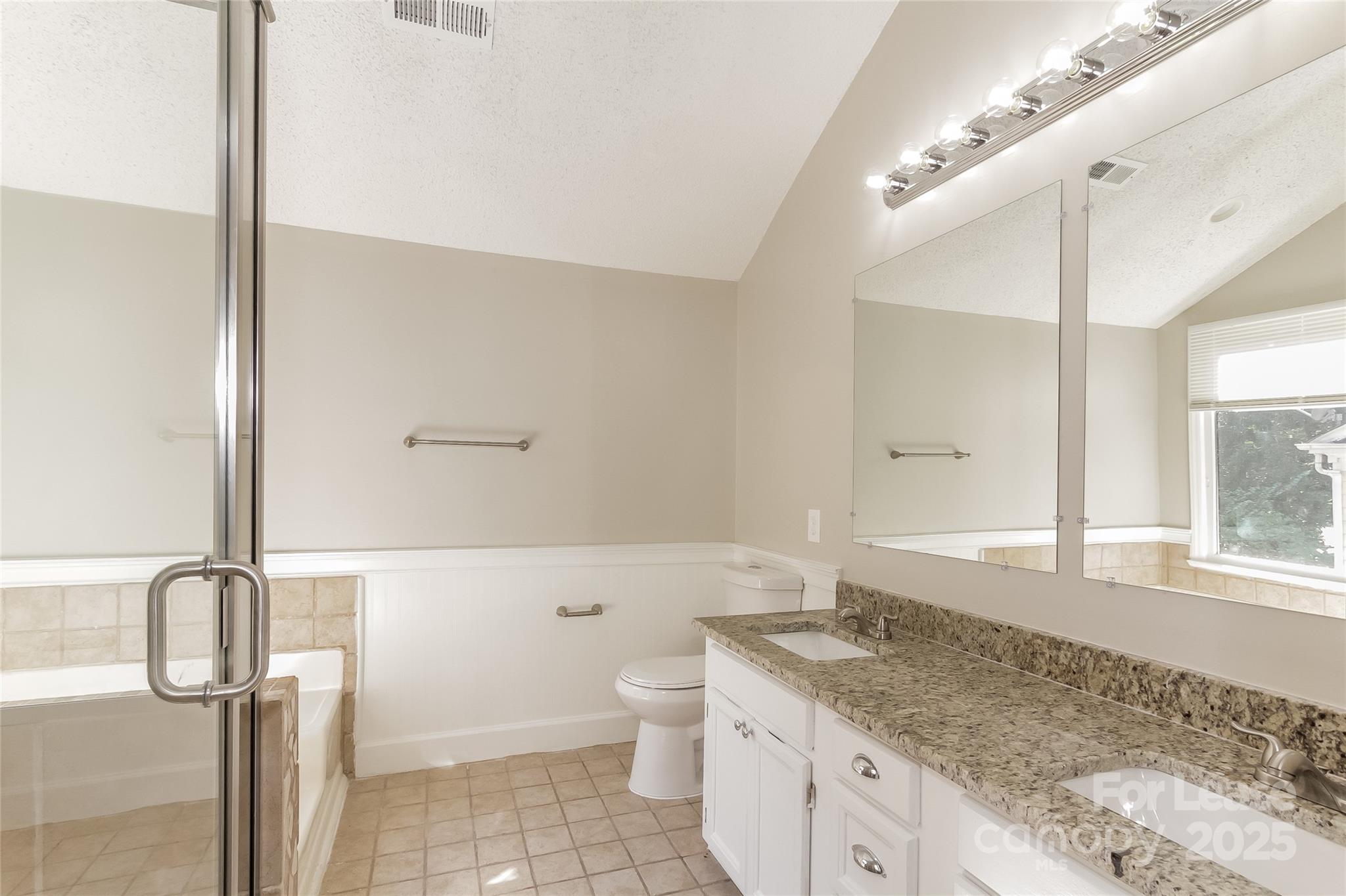 926 Eldorado Avenue Charlotte, NC 28262 - Photo 13 of 17 a spacious bathroom with a granite countertop sink a toilet and a shower