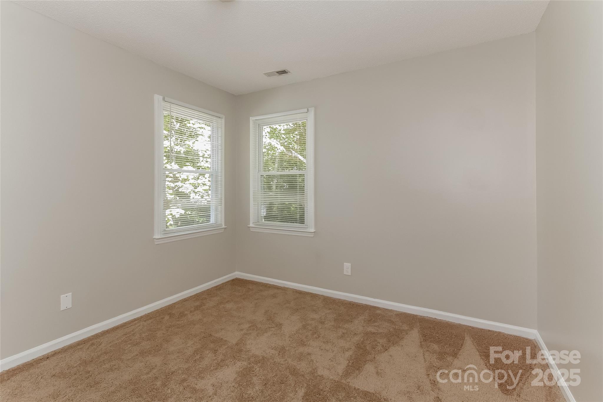 926 Eldorado Avenue Charlotte, NC 28262 - Photo 14 of 17 an empty room with windows