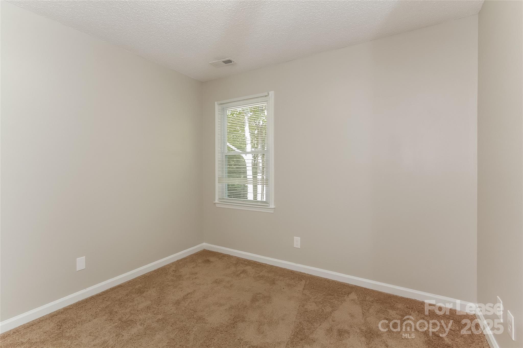 926 Eldorado Avenue Charlotte, NC 28262 - Photo 15 of 17 an empty room with a window