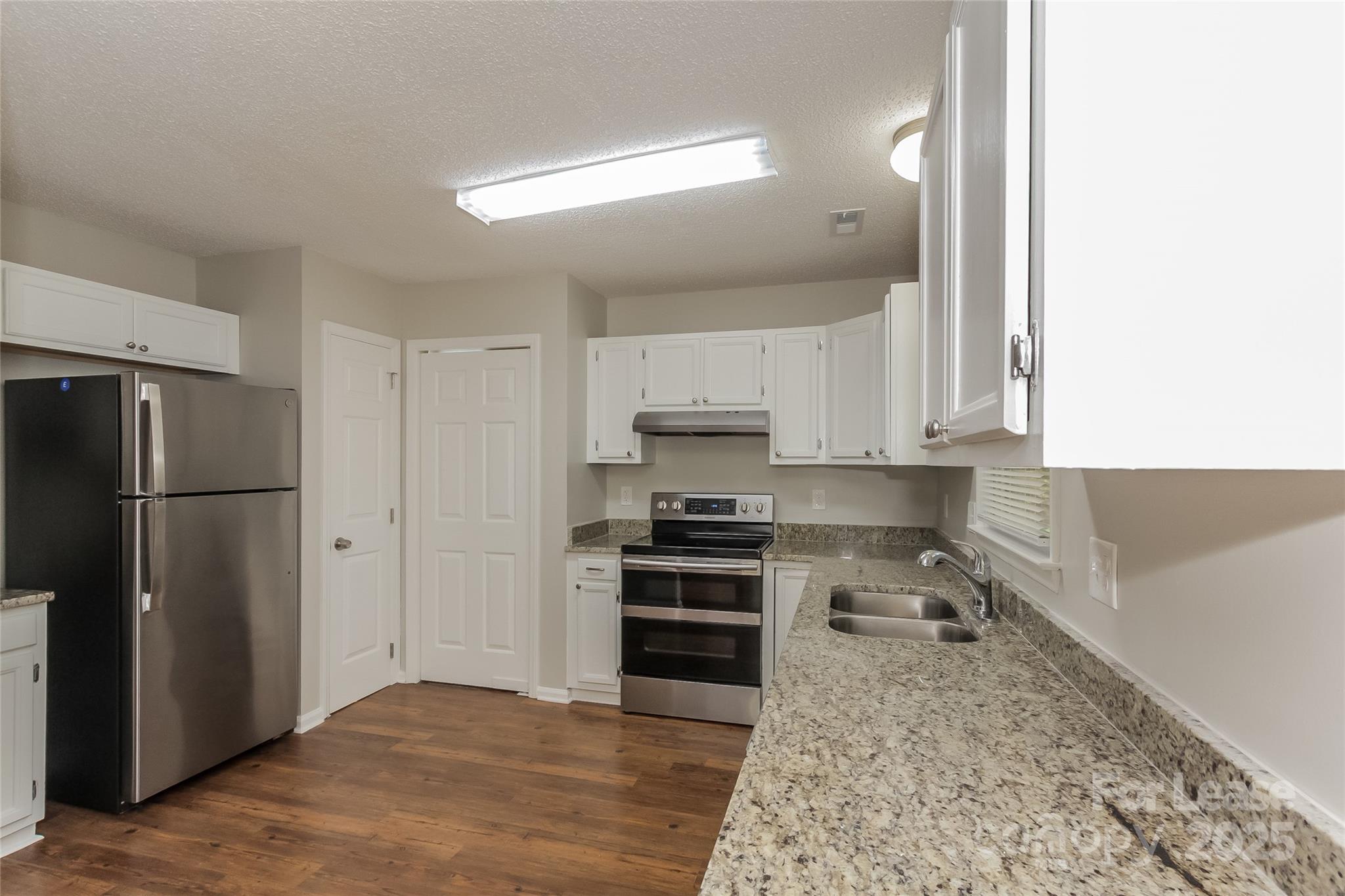 926 Eldorado Avenue Charlotte, NC 28262 - Photo 8 of 17 a kitchen with a refrigerator sink and cabinets