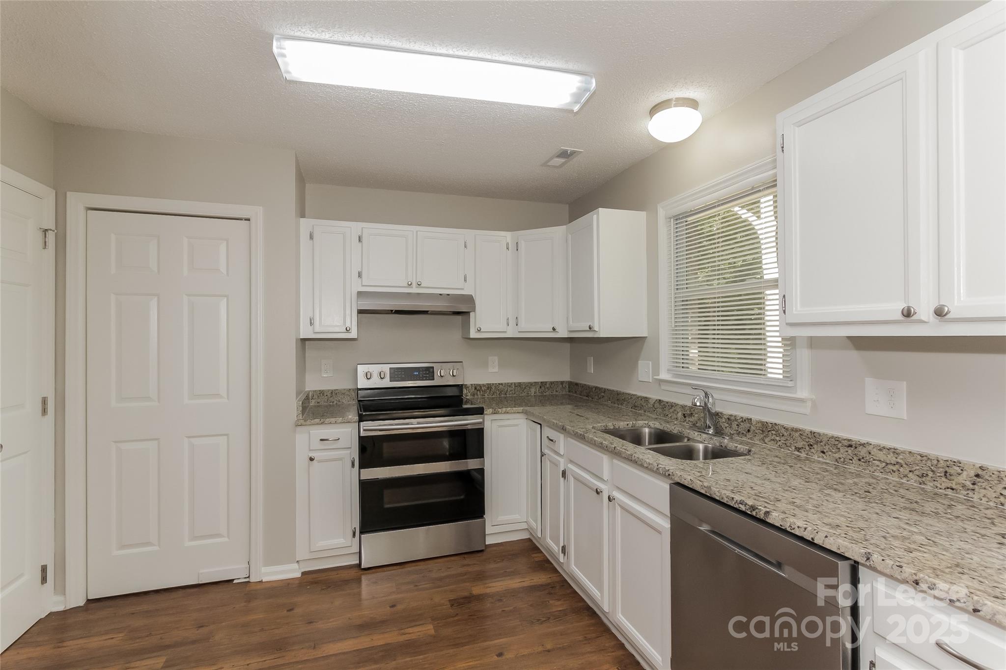 926 Eldorado Avenue Charlotte, NC 28262 - Photo 9 of 17 a kitchen with granite countertop a sink cabinets stainless steel appliances and a window