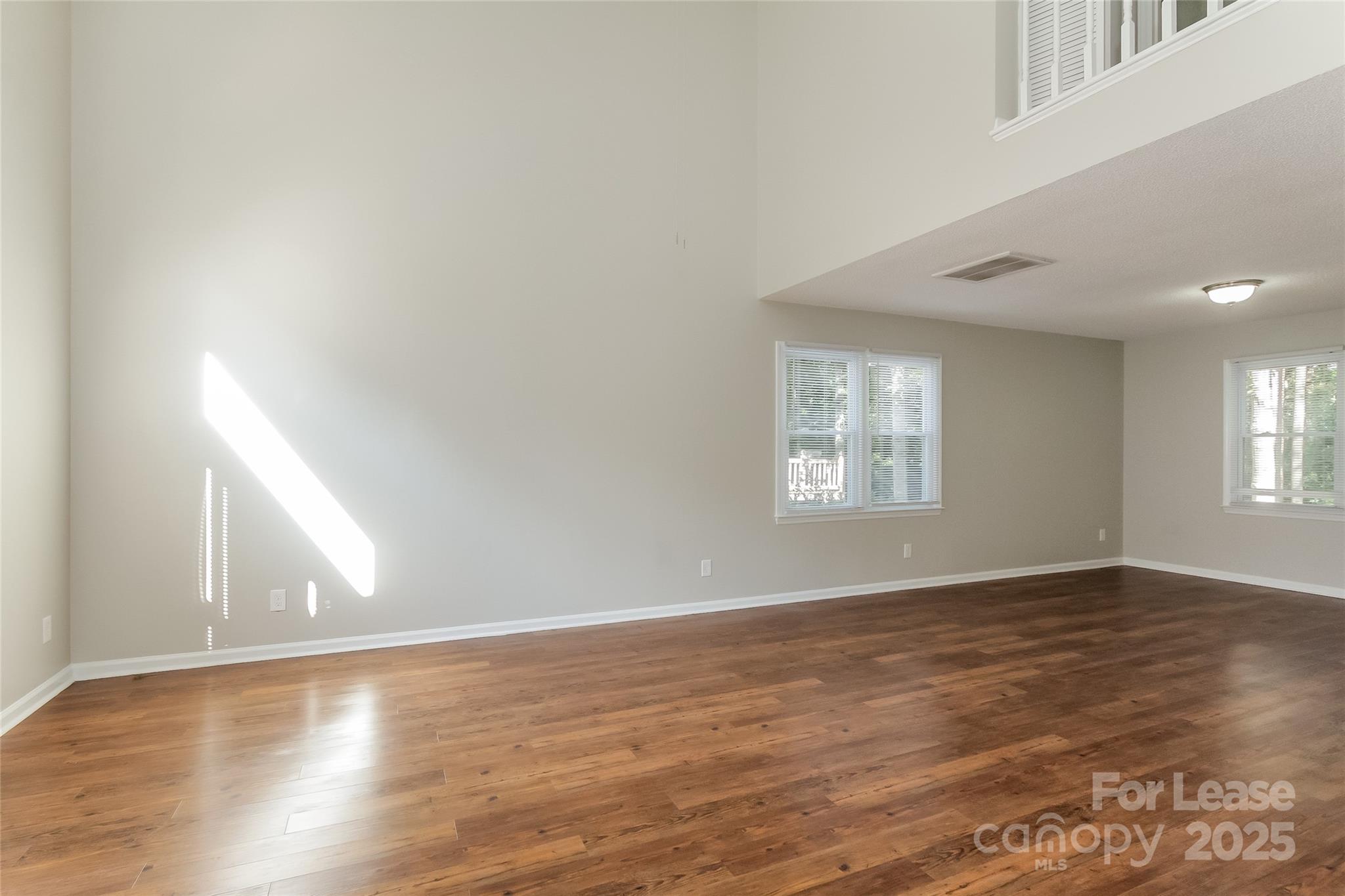 926 Eldorado Avenue Charlotte, NC 28262 - Photo 10 of 17 a view of an empty room with wooden floor and a window
