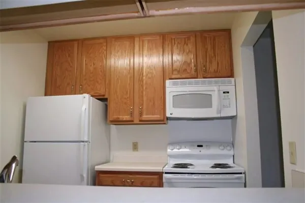 a white refrigerator freezer sitting inside of a kitchen