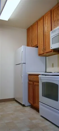 a kitchen with granite countertop cabinets and steel stainless steel appliances