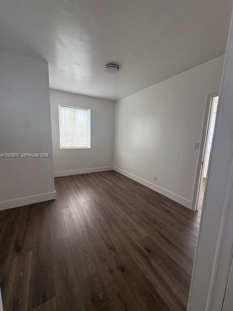 2052 Southwest 7th Street, Unit 4 Miami, FL 33135 - Photo 9 of 10 an empty room with wooden floor and windows