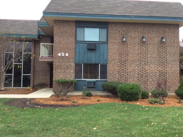 454 Spring Road, Unit 8 Elmhurst, IL 60126 - Photo 1 of 14 a front view of a house with a yard