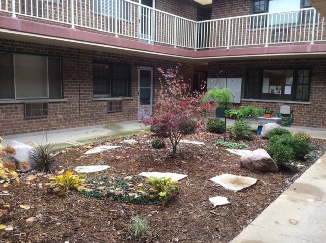 454 Spring Road, Unit 8 Elmhurst, IL 60126 - Photo 10 of 14 a front view of a house with a yard