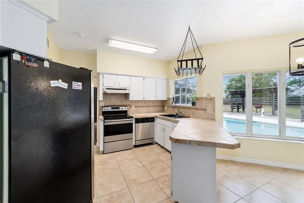 a view of a dining room with furniture and a potted plant
