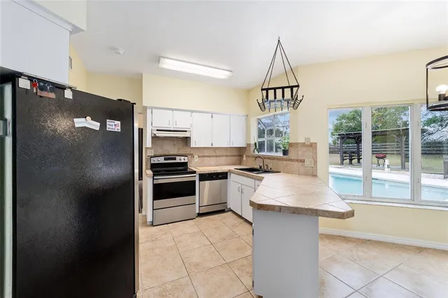 a view of a dining room with furniture and a potted plant
