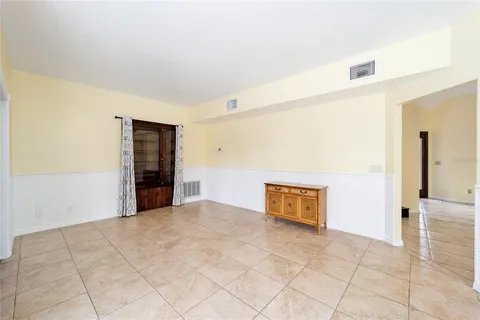 a view of a hallway with wooden floor and closet