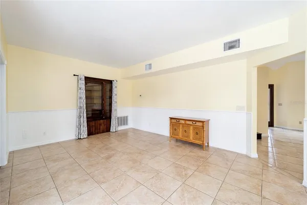 a view of a hallway with wooden floor and closet