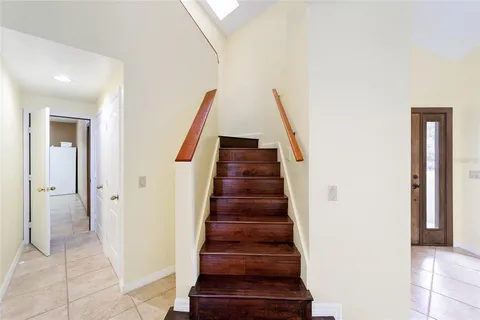 a bedroom with a bed and a window with wooden floor