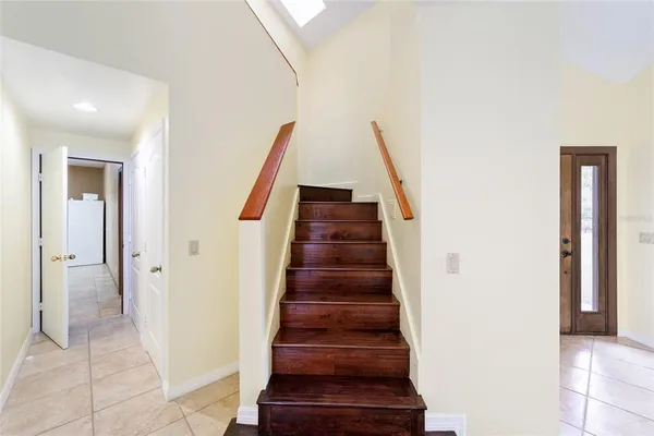 a bedroom with a bed and a window with wooden floor