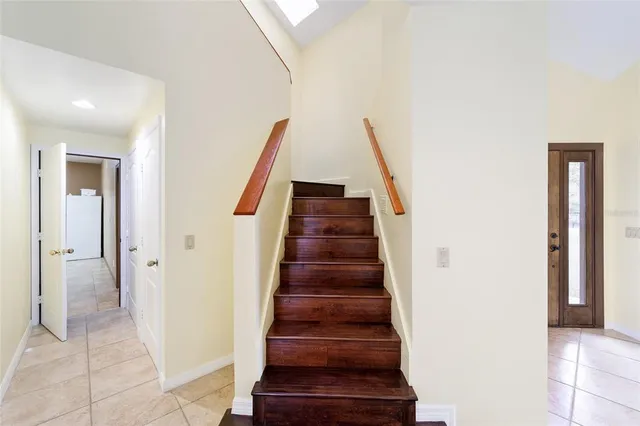a bedroom with a bed and a window with wooden floor
