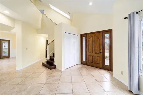 a view of a livingroom with wooden floor and a flat screen tv