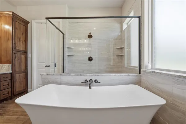 a bathroom with a bathtub and a shower