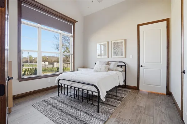 a bedroom with a bed and a large window