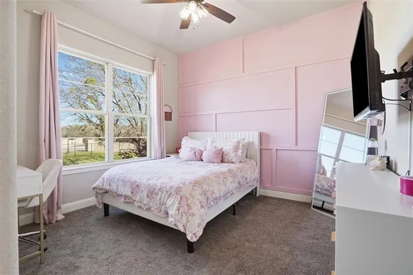 a bed room with a bed and a flat tv screen