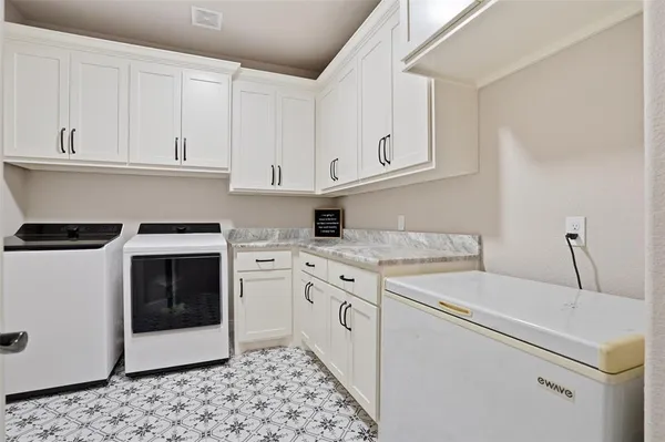 a kitchen with cabinets appliances and a sink