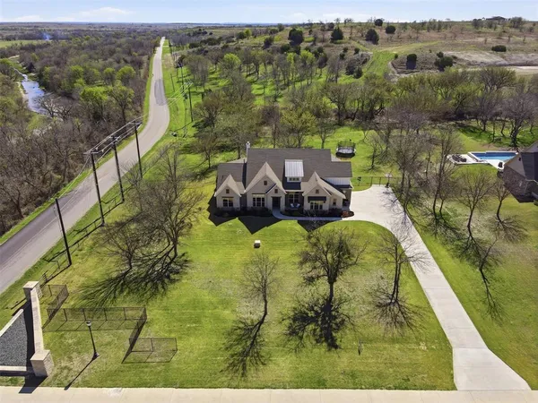 an aerial view of a house with a yard basket ball court