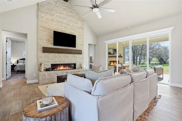 a living room with furniture a fireplace and a flat screen tv