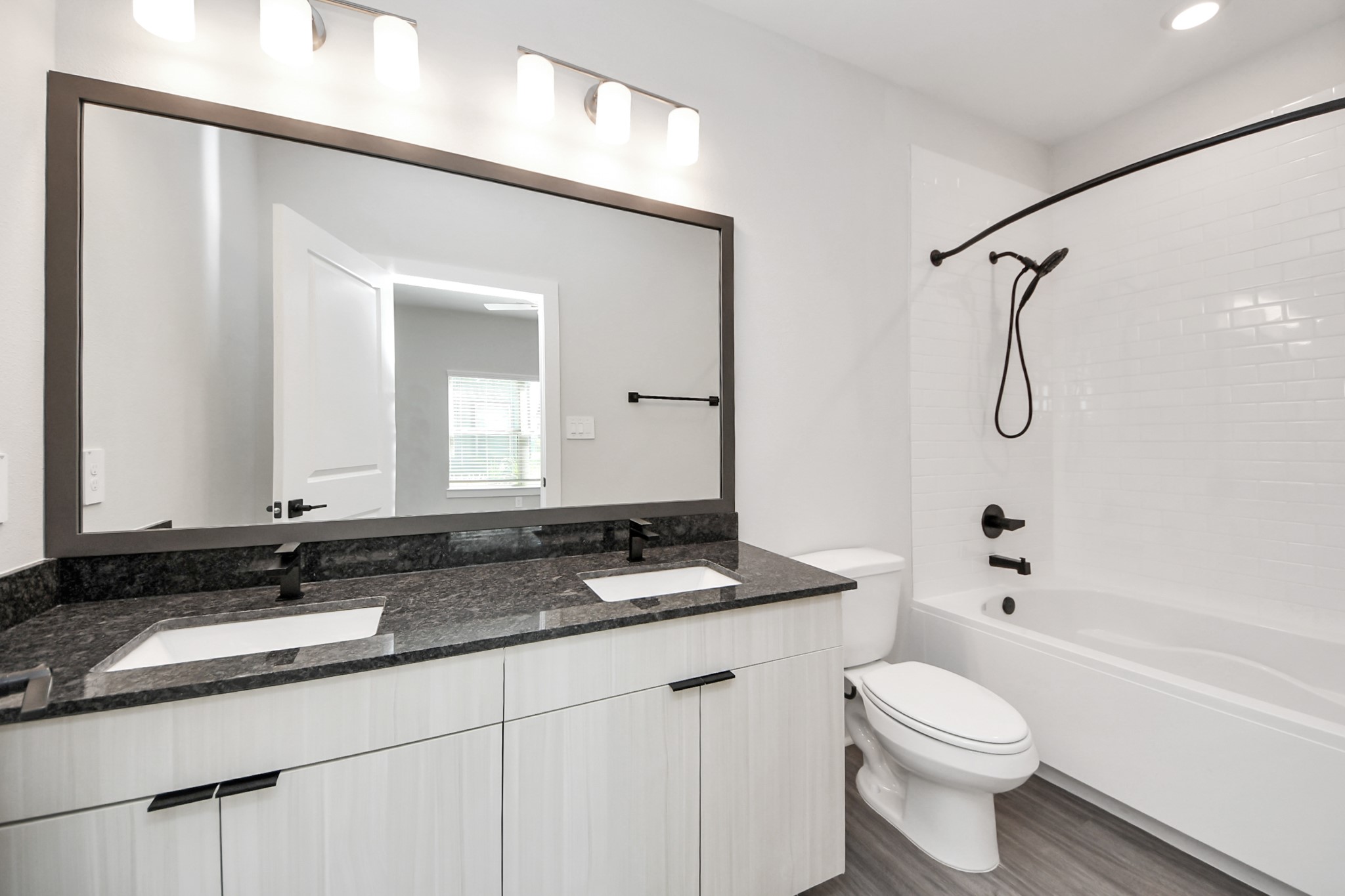 7711 Longmire Road, Unit 57 Conroe, TX 77304 - Photo 14 of 48 Primary Suite offers walk-closet,bath w/dual vanities&lux tub/shower.