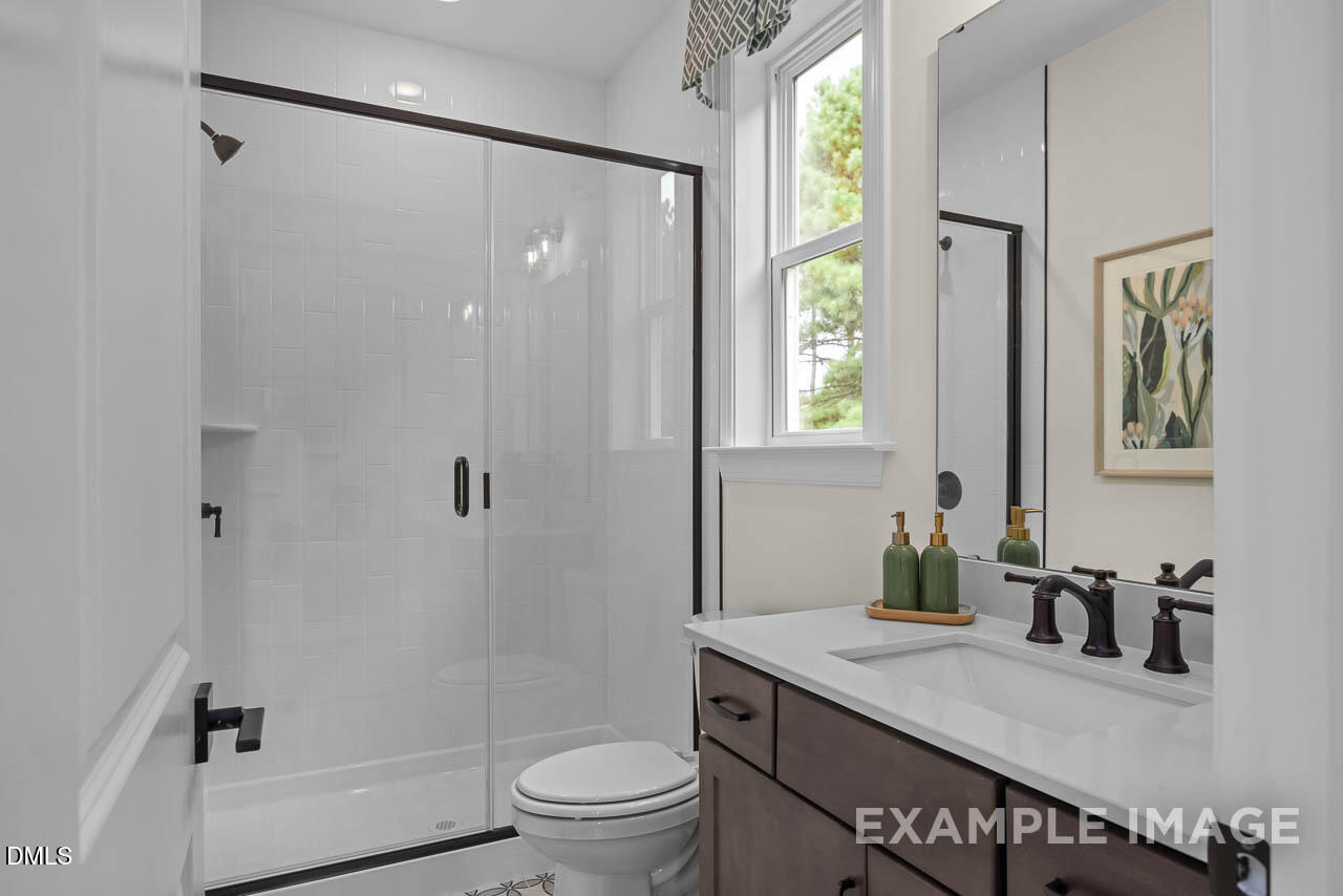 83 Crop Road Angier, NC 27501 - Photo 20 of 40 a bathroom with a granite countertop sink a toilet a mirror and shower