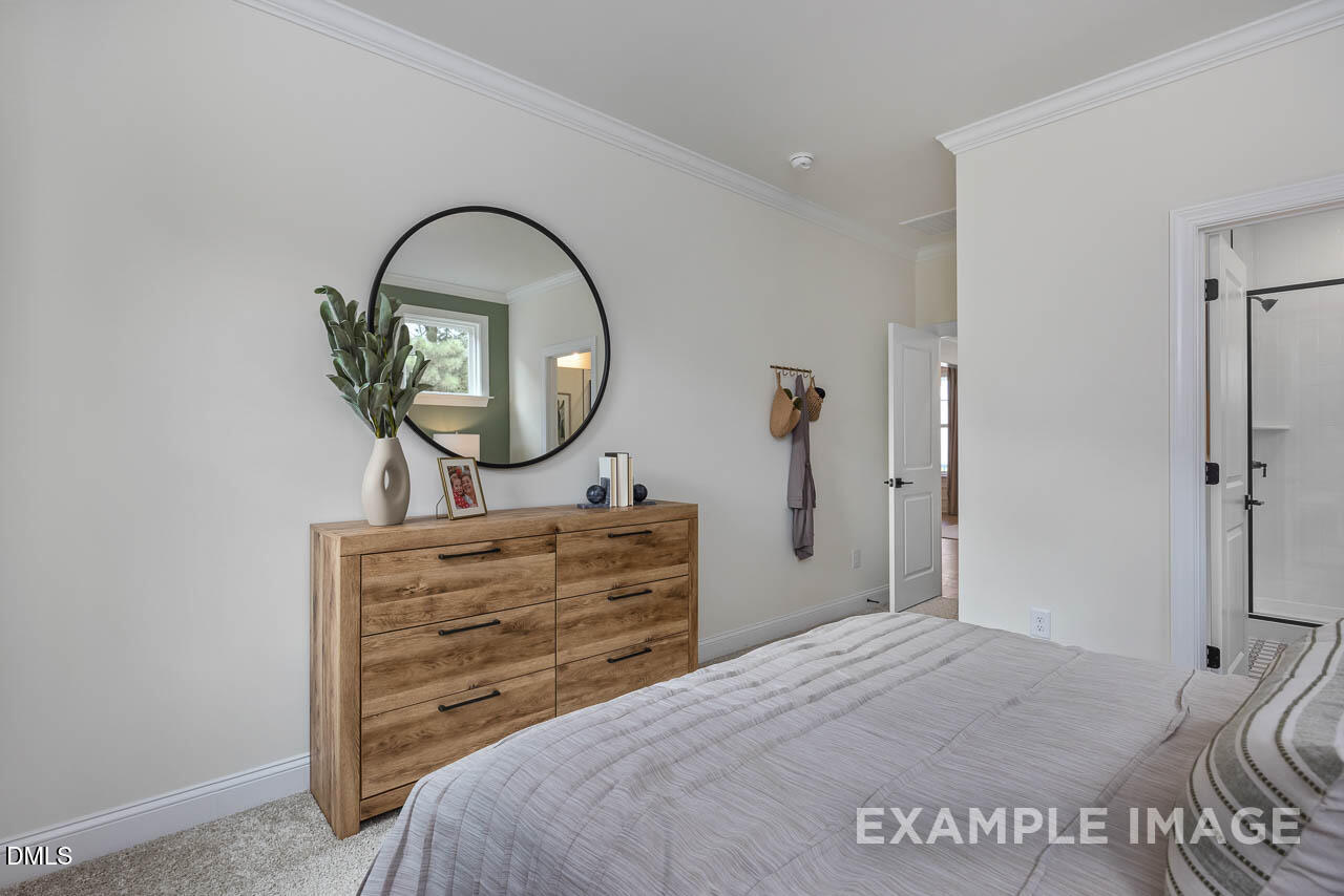 83 Crop Road Angier, NC 27501 - Photo 21 of 40 a view of a bedroom with a bed and dresser