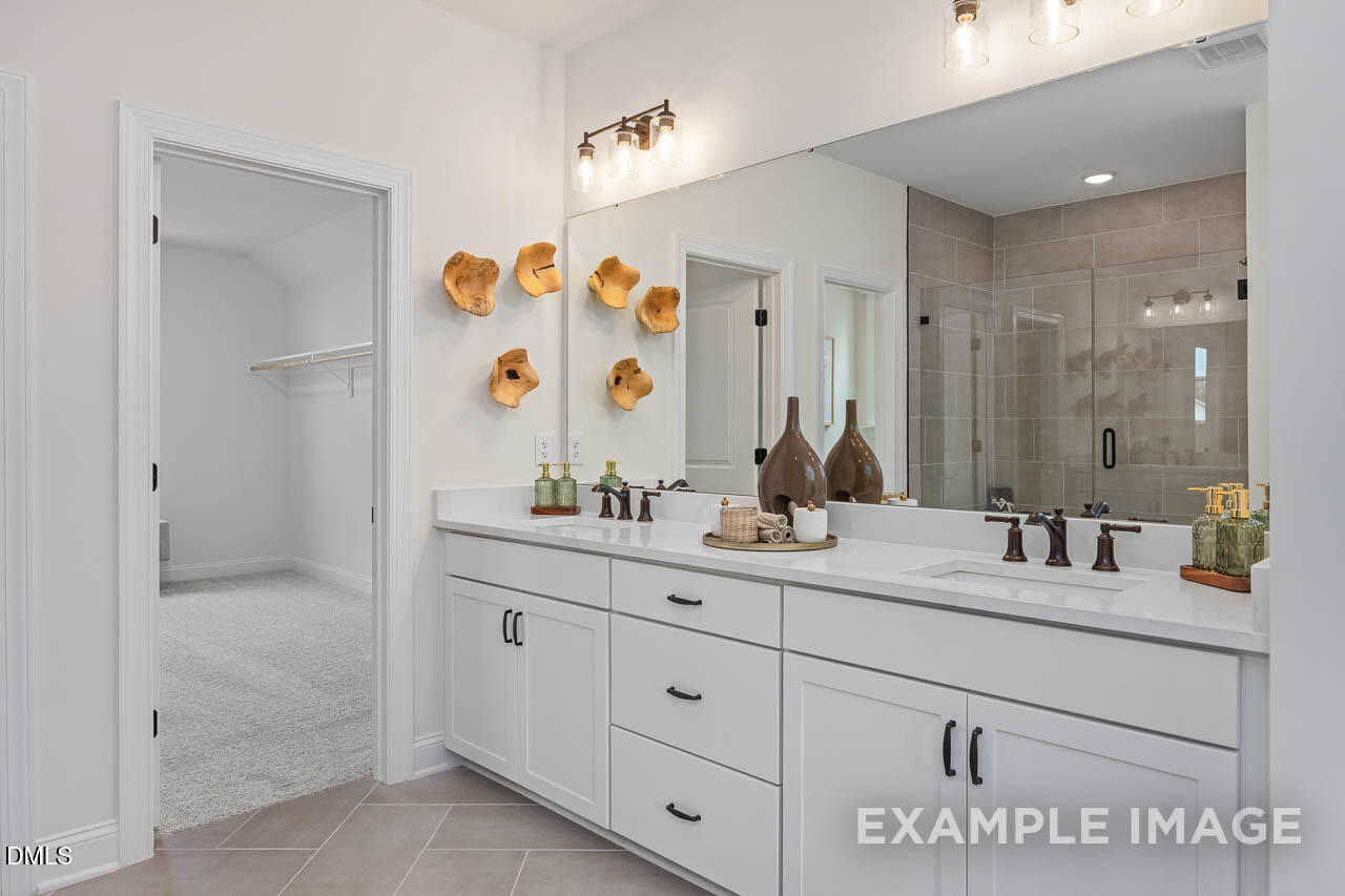 83 Crop Road Angier, NC 27501 - Photo 28 of 40 a bathroom with a double vanity sink mirror and