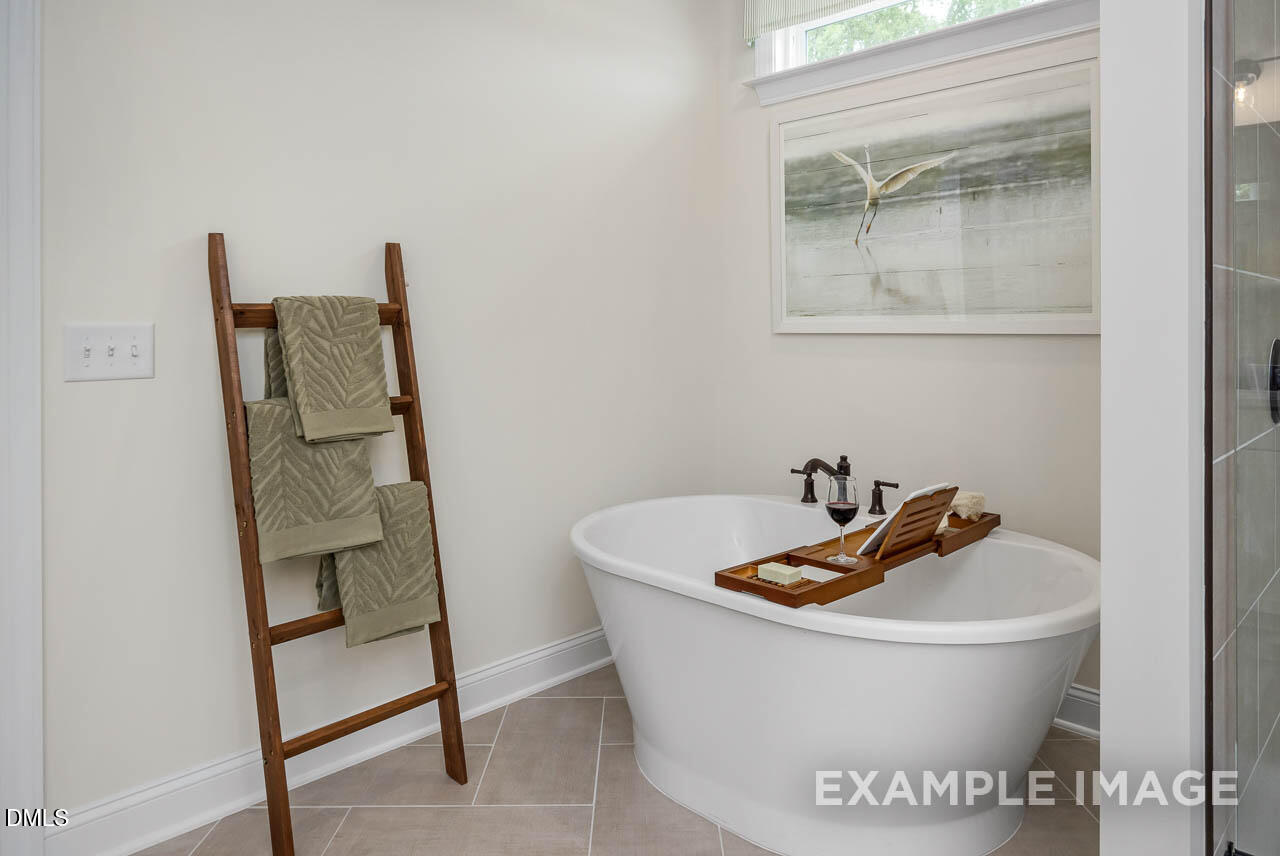 83 Crop Road Angier, NC 27501 - Photo 29 of 40 a white bath tub sitting next to a small vanity