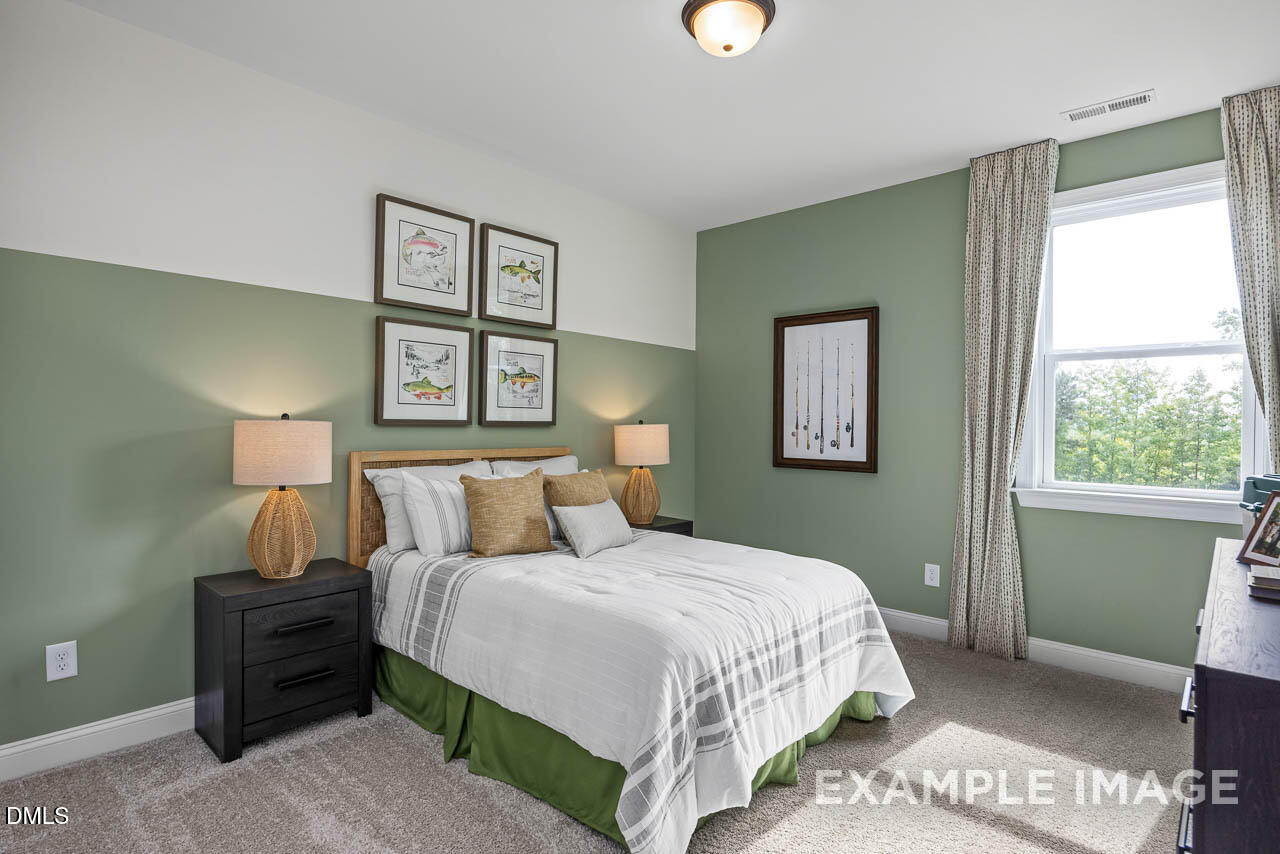 83 Crop Road Angier, NC 27501 - Photo 32 of 40 a bedroom with a bed and a window