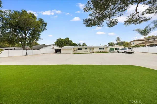 a view of a field of grass and a building