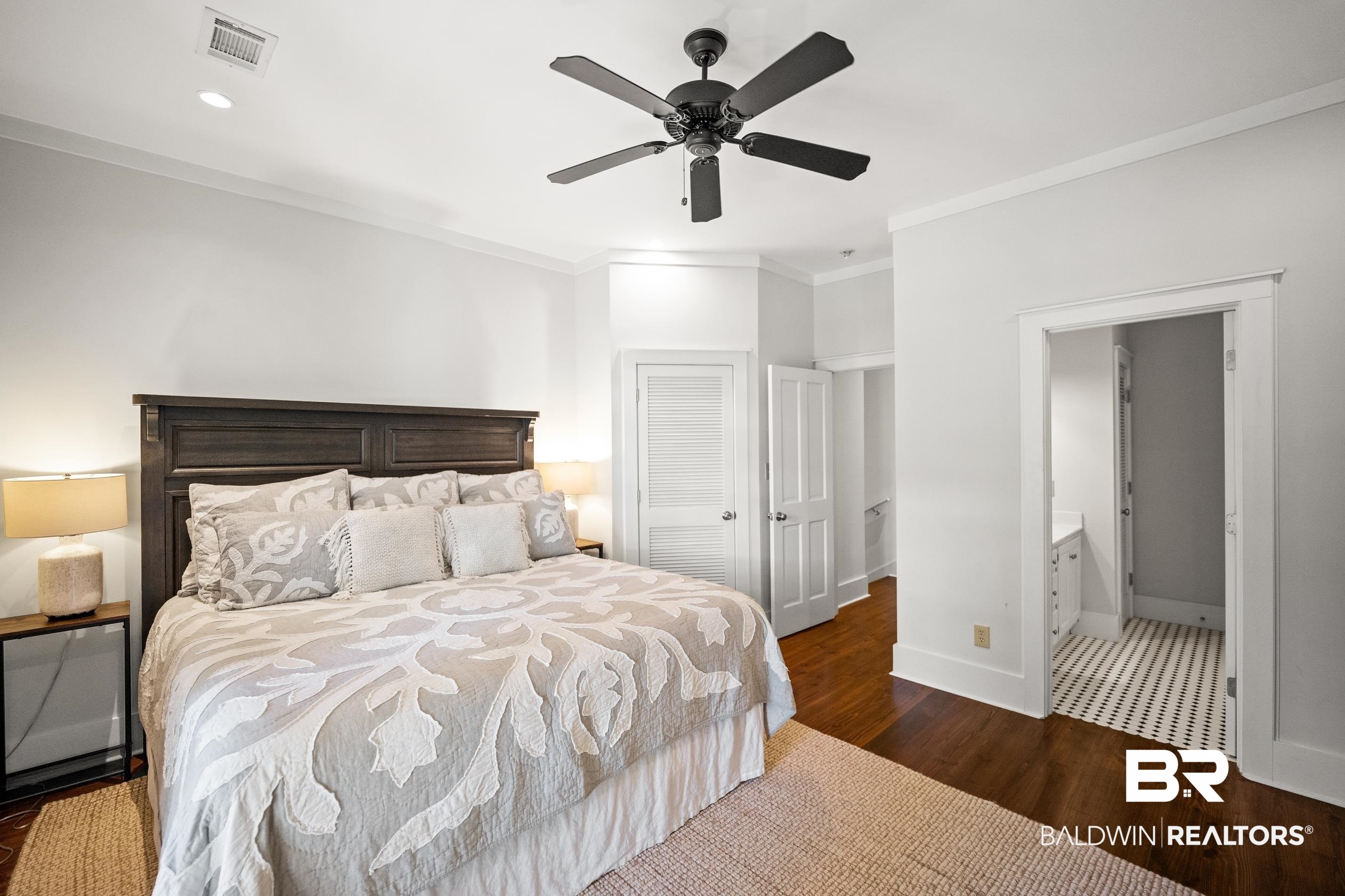 25773 Canal Road, Unit 28 Orange Beach, AL 36561 - Photo 19 of 48 Bedroom with dark wood-type flooring, crown molding, connected bathroom, ceiling fan, and a closet