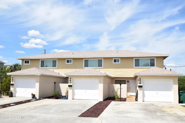 a kitchen with a refrigerator a sink and cabinets