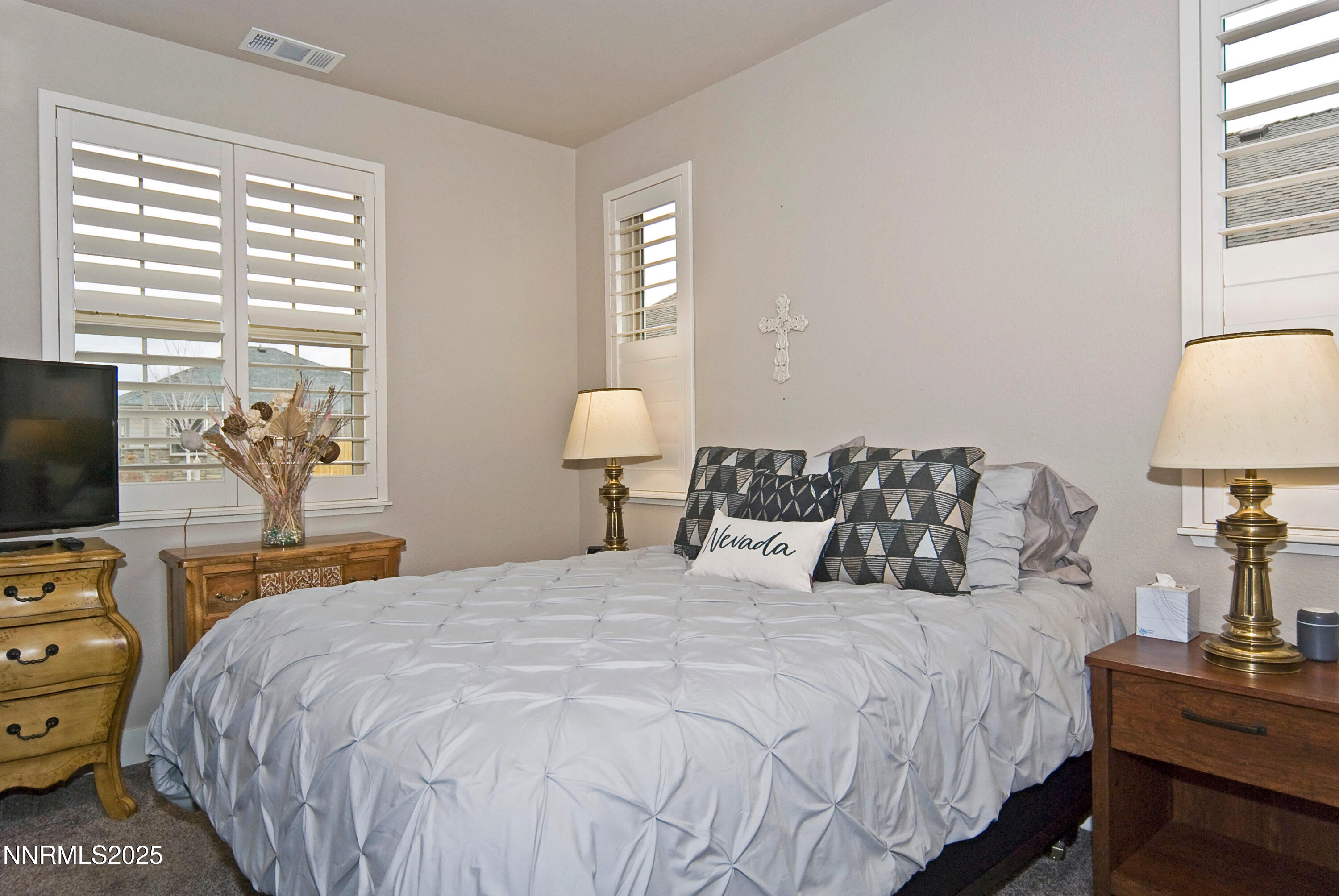 768 East Cottage Loop Gardnerville, NV 89460 - Photo 18 of 23 a bedroom with a bed and a flat tv screen on the dresser