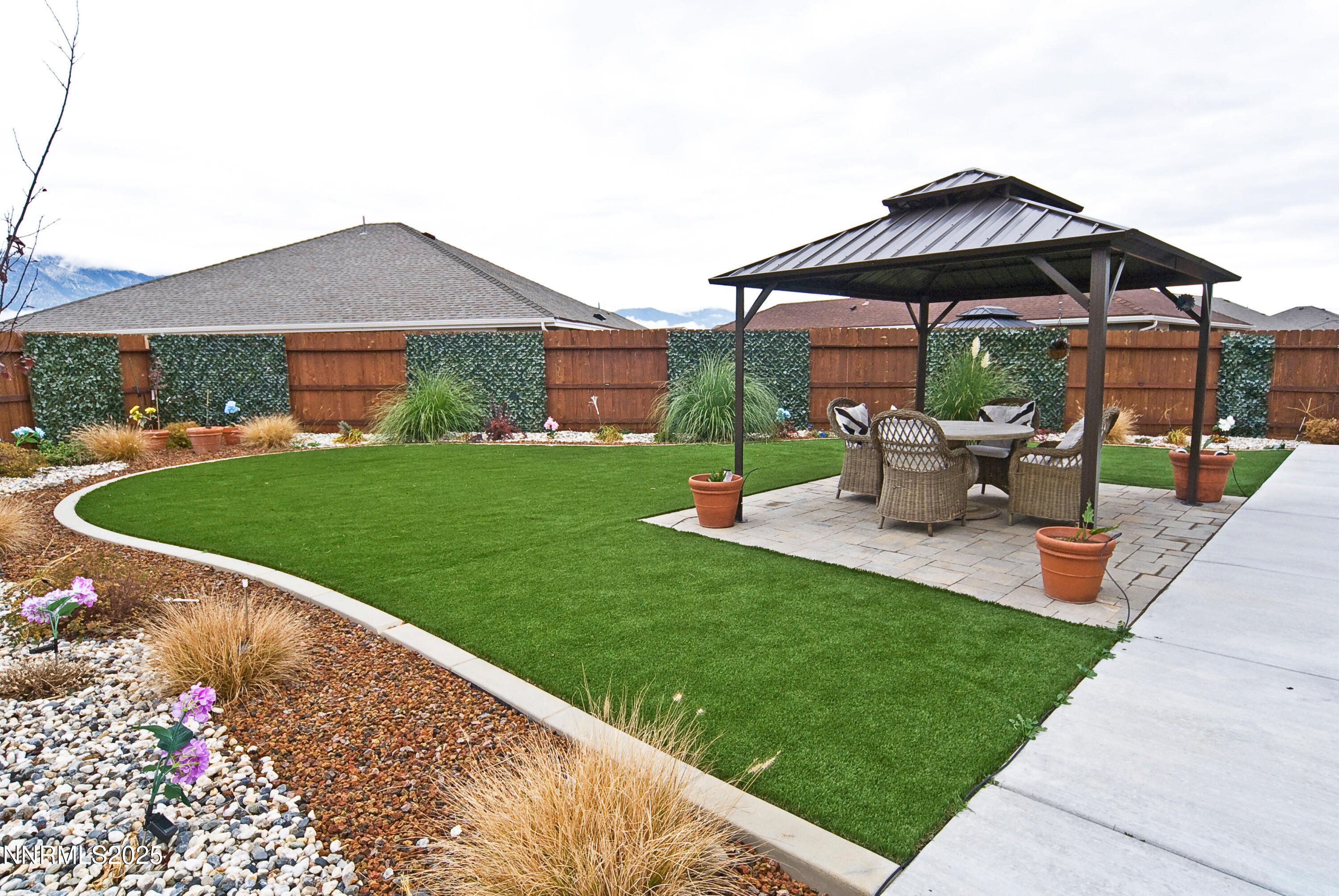 768 East Cottage Loop Gardnerville, NV 89460 - Photo 20 of 23 a view of a house with backyard sitting area and garden