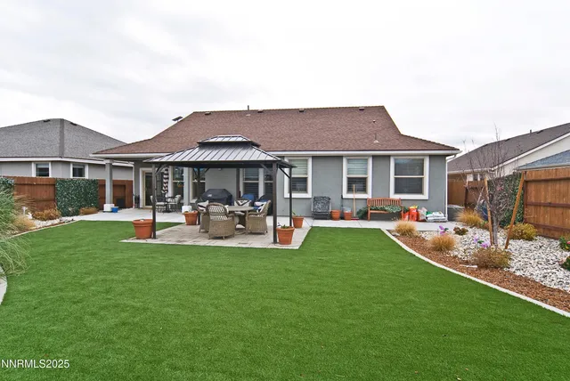 a front view of a house with garden and patio