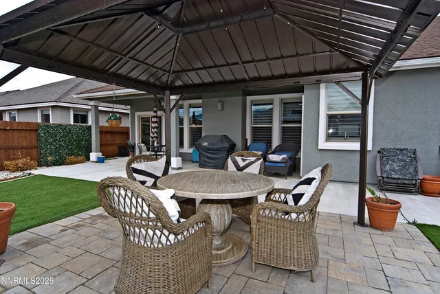 a view of a patio with table and chairs