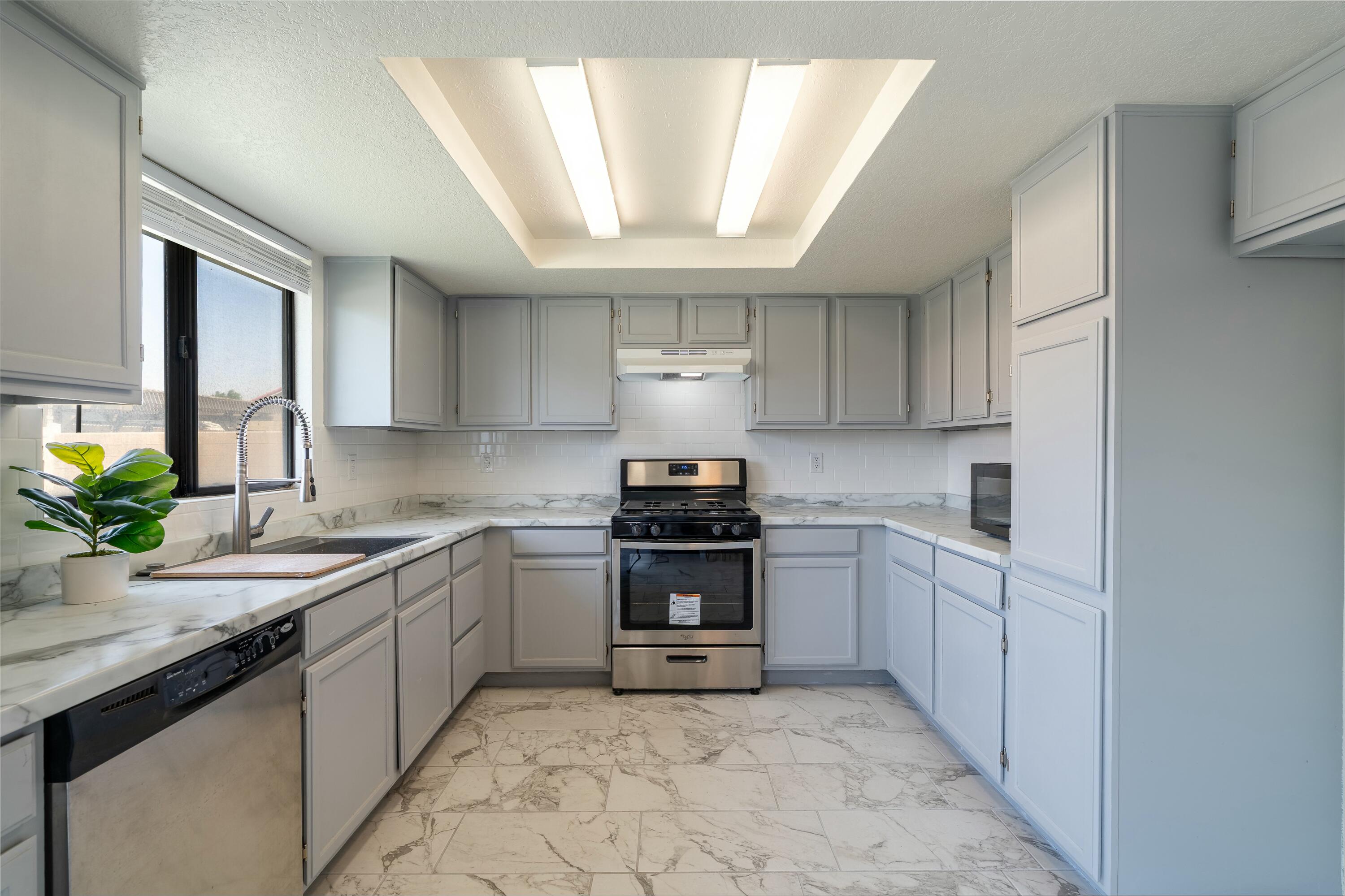 69290 El Dobe Road Cathedral City, CA 92234 - Photo 12 of 42 a kitchen with a sink stove and cabinets