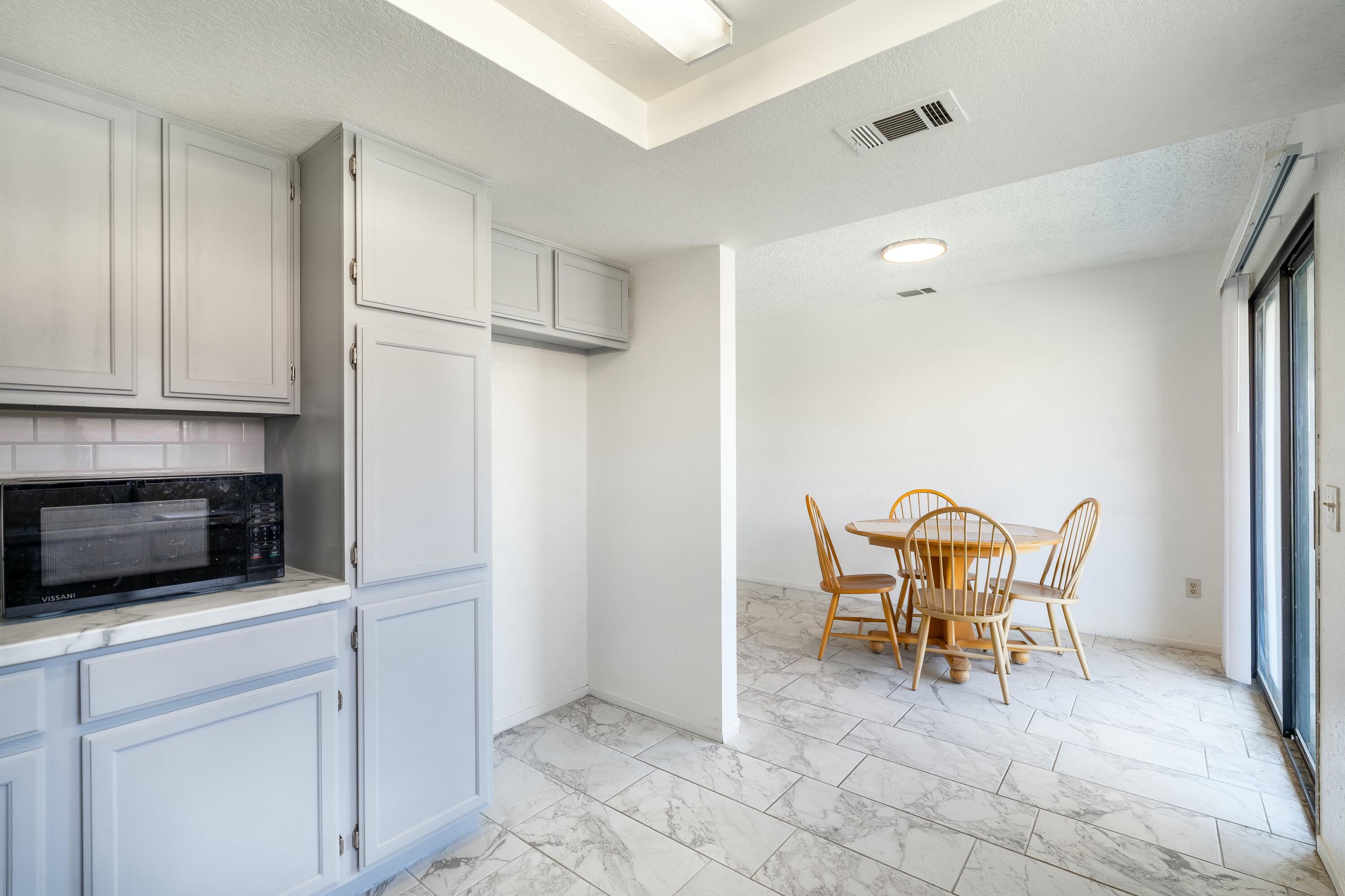 69290 El Dobe Road Cathedral City, CA 92234 - Photo 15 of 42 a view of a kitchen with furniture and wooden floor