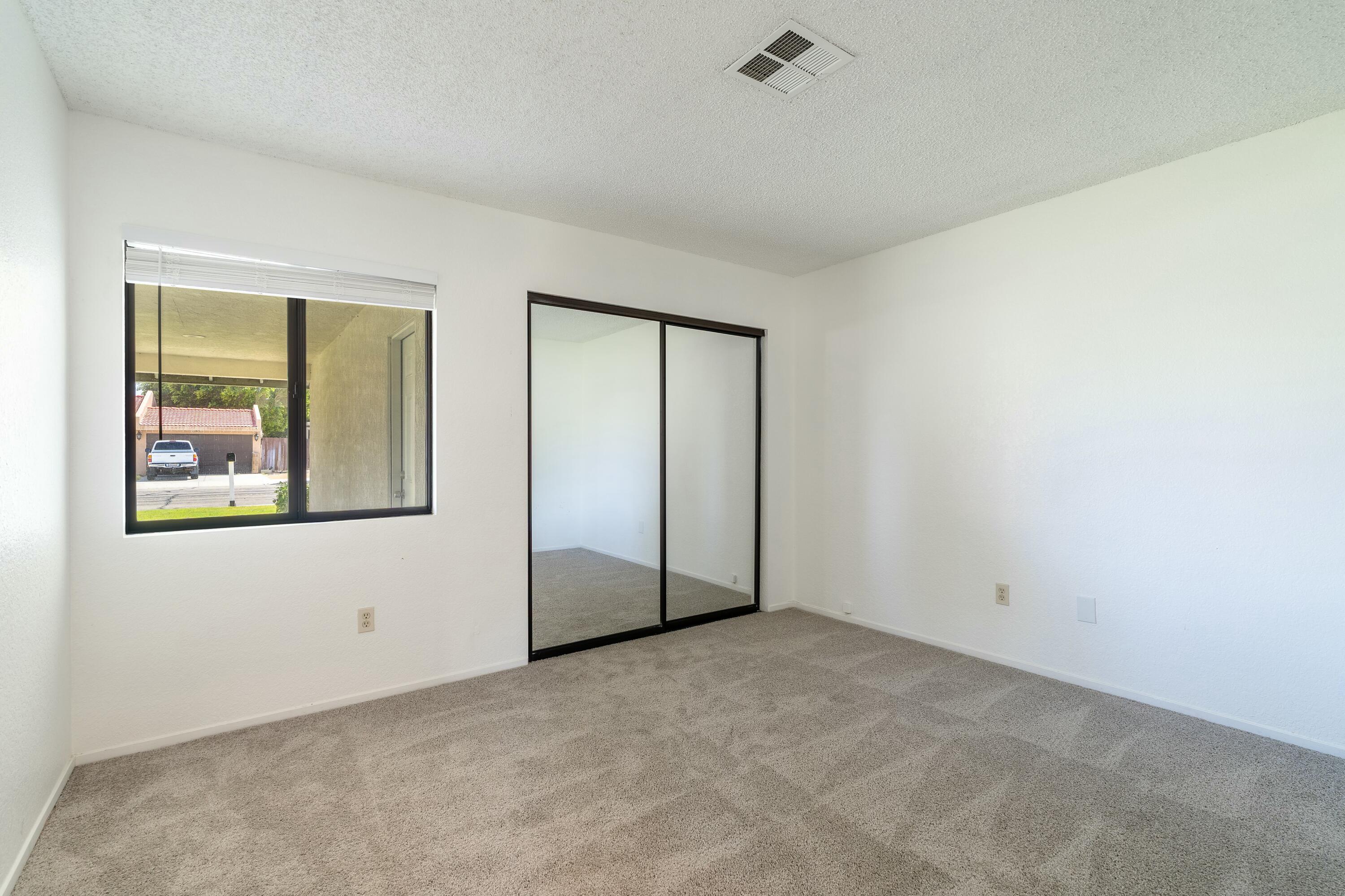 69290 El Dobe Road Cathedral City, CA 92234 - Photo 17 of 42 an empty room with windows and closet