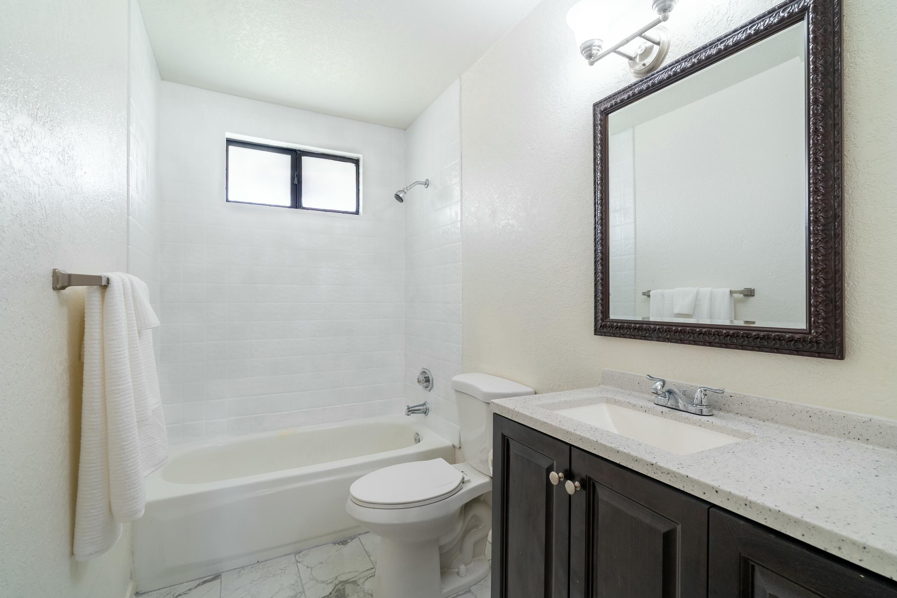 69290 El Dobe Road Cathedral City, CA 92234 - Photo 19 of 42 a bathroom with a granite countertop sink toilet and shower
