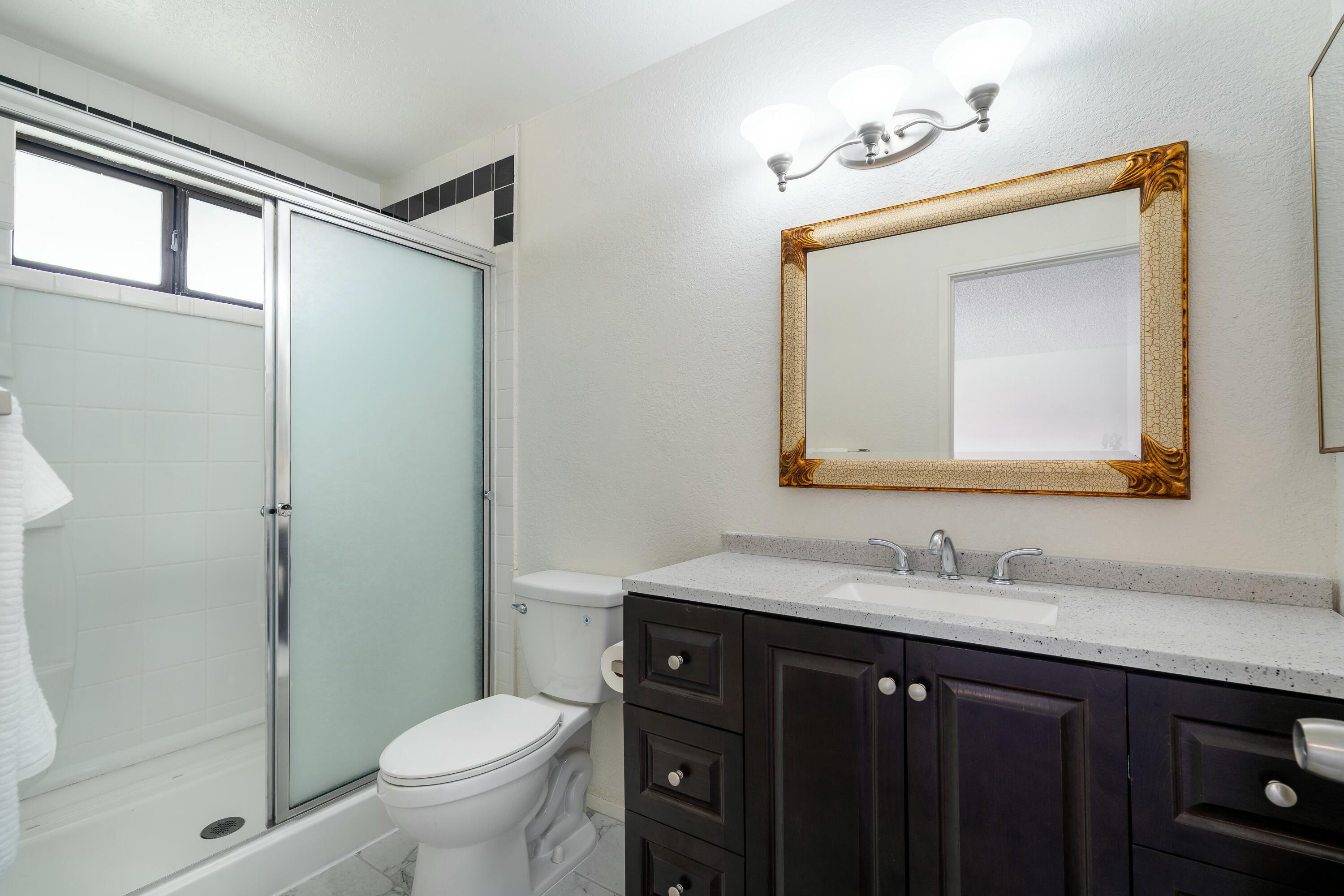 69290 El Dobe Road Cathedral City, CA 92234 - Photo 26 of 42 a bathroom with a toilet a sink a vanity and mirror
