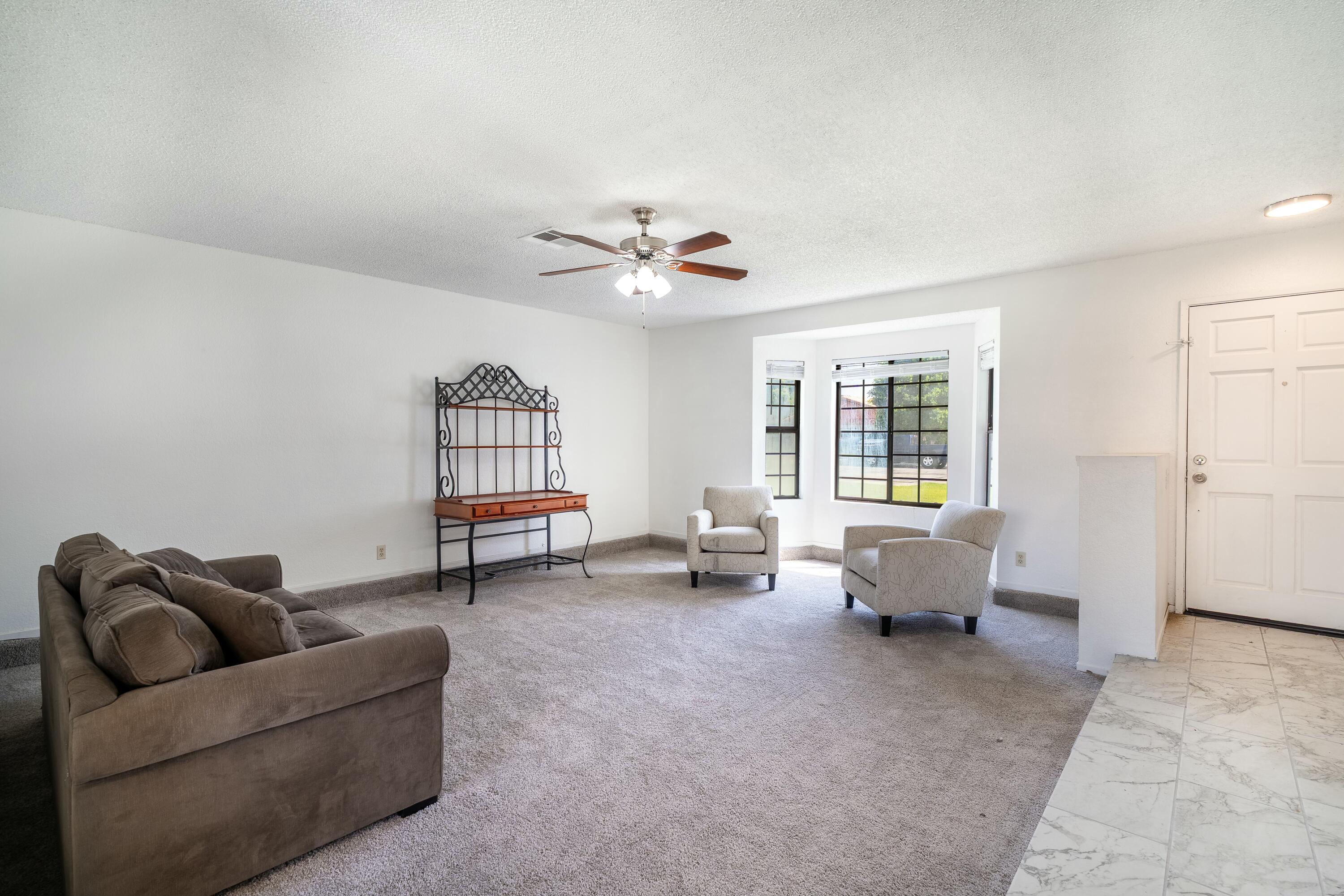 69290 El Dobe Road Cathedral City, CA 92234 - Photo 7 of 42 a living room with furniture and a window