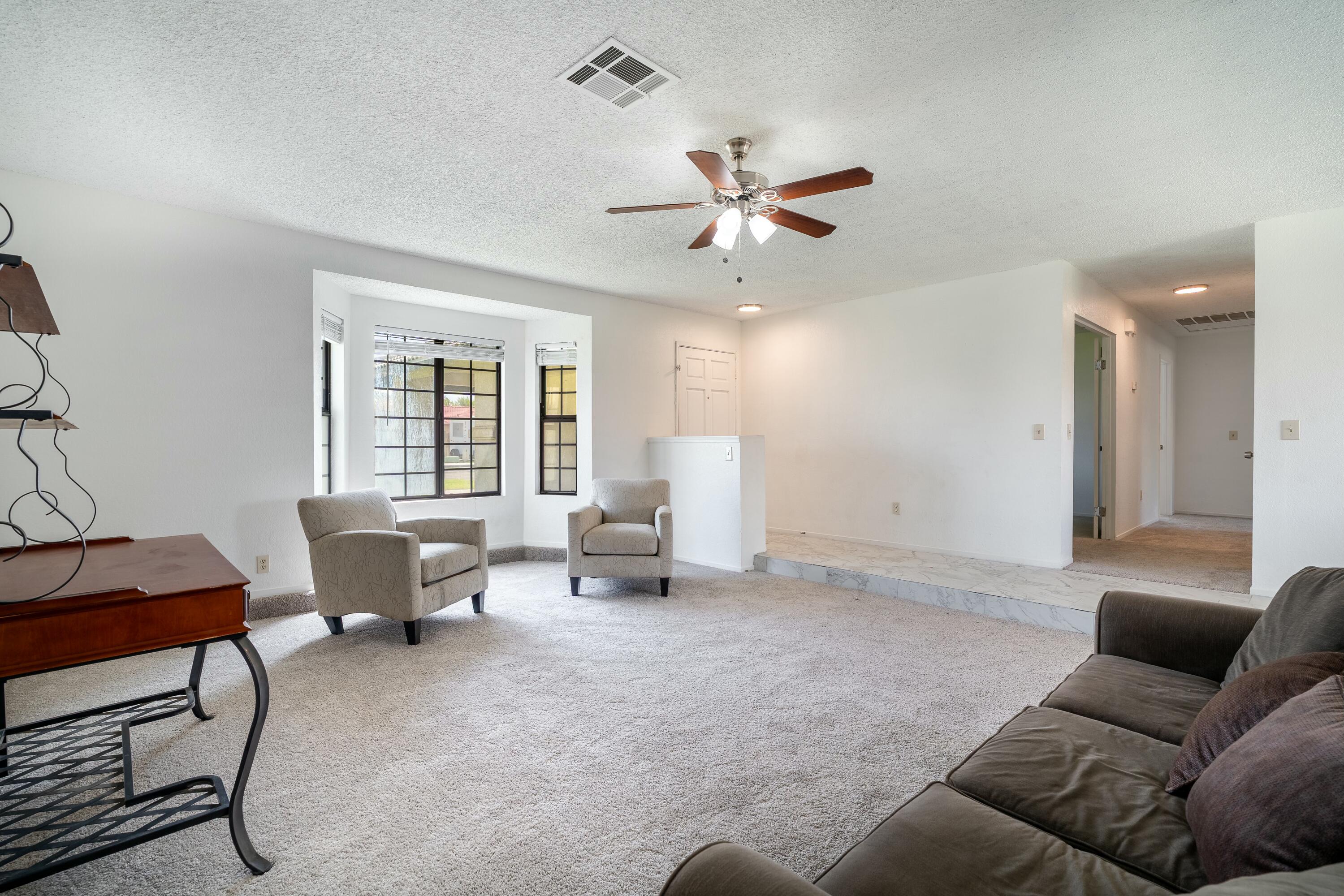 69290 El Dobe Road Cathedral City, CA 92234 - Photo 8 of 42 a living room with furniture and a window