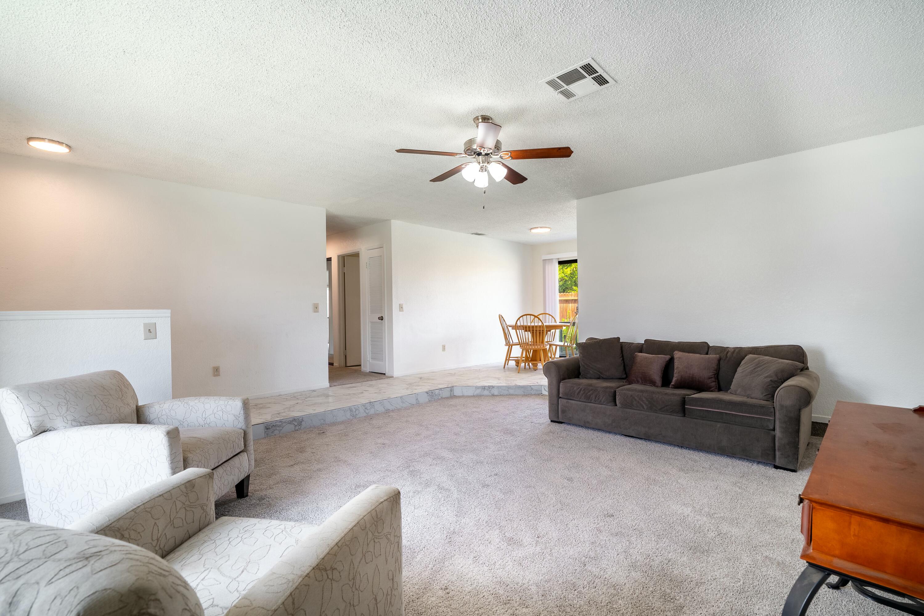 69290 El Dobe Road Cathedral City, CA 92234 - Photo 9 of 42 a living room with furniture and a ceiling fan