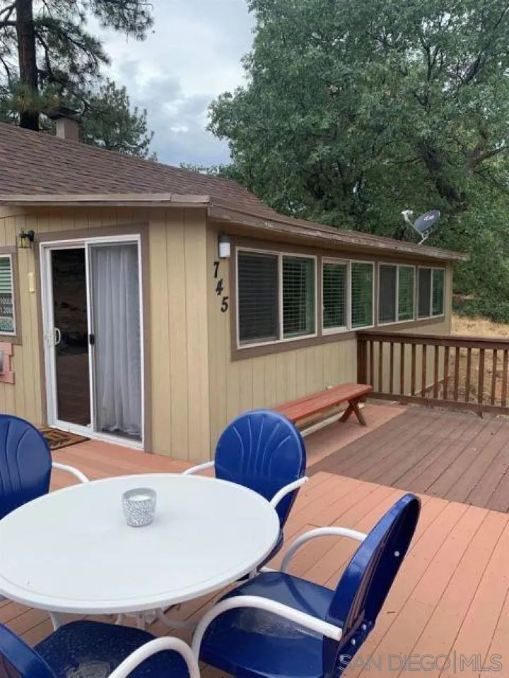 745 Boiling Springs Road Mount Laguna, CA 91948 - Photo 7 of 24 a view of a patio with table and chairs with wooden floor and fence