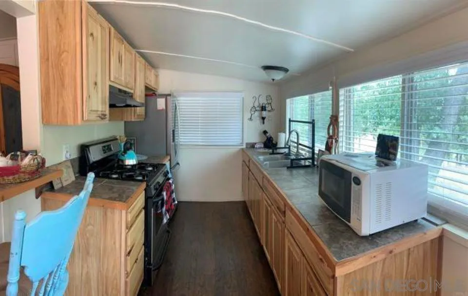 745 Boiling Springs Road Mount Laguna, CA 91948 - Photo 10 of 24 a kitchen with sink refrigerator and window