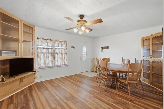 a view of a dining room with furniture and a window